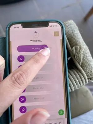 a hand pointing at the welcome screen on an iphone at The LIF Boutique in Amsterdam