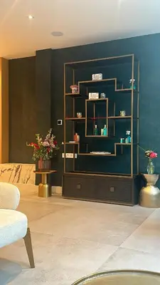 a living room with a book shelf with flowers on it at The LIF Boutique in Amsterdam