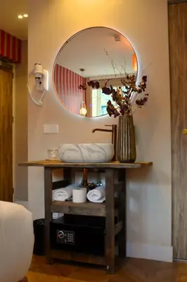 a bathroom with a mirror on a table with towels at The LIF Boutique in Amsterdam