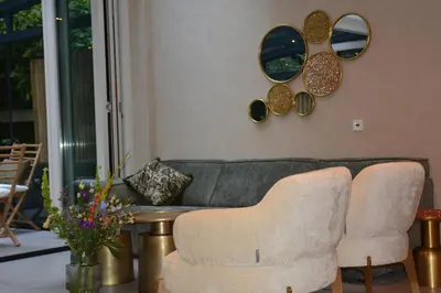 a living room with a couch and mirrors on the wall at The LIF Boutique in Amsterdam