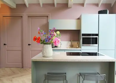 a kitchen with a vase of flowers on a counter at De Bosuil in Bergen