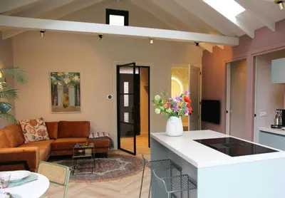 a living room with a couch and a table at De Bosuil in Bergen