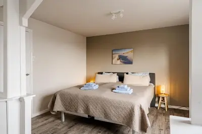 a bedroom with a bed with two towels on it at Short Stay Zandvoort in Zandvoort