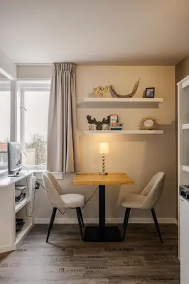 a kitchen with a table and two chairs at Short Stay Zandvoort in Zandvoort
