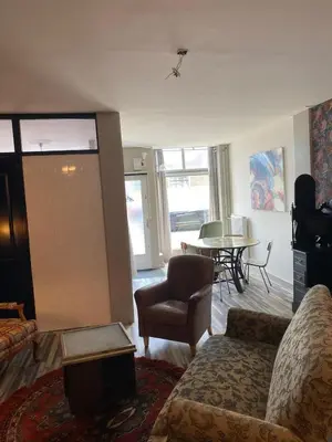 a living room with a couch and a table at Friend zone in Zaandam