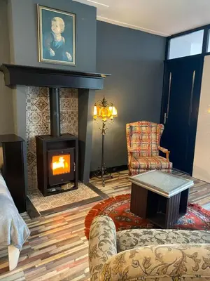 a living room with a fireplace and a couch at Friend zone in Zaandam