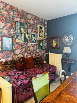 a living room with a bed and a wall covered in flowers at Friend zone in Zaandam