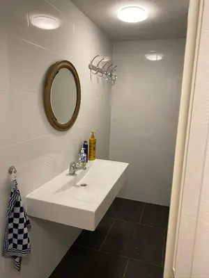 a bathroom with a white sink and a mirror at Friend zone in Zaandam