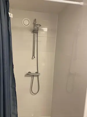 a shower with a shower head in a bathroom at Friend zone in Zaandam