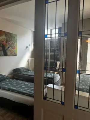 a room with two beds and a mirror at Friend zone in Zaandam