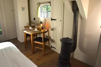 a small room with a table and a window at Bed & Breakfast Puur Natuur Putten, met privé sauna in Putten