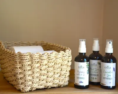 three bottles of wine sitting next to a basket at Bed & Breakfast Puur Natuur Putten, met privé sauna in Putten
