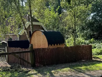 a wooden fence in front of a house at Bed & Breakfast Puur Natuur Putten, met privé sauna in Putten