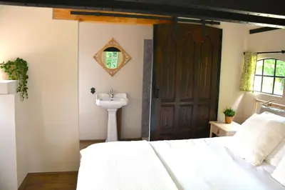a bedroom with a white bed and a sink at Bed & Breakfast Puur Natuur Putten, met privé sauna in Putten
