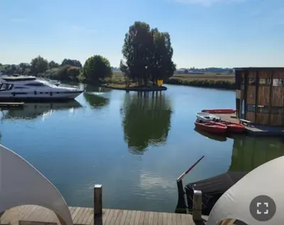 a view of a river with boats in it at Luxe vrijstaand gastenverblijf - landelijk gelegen in IJsselstein