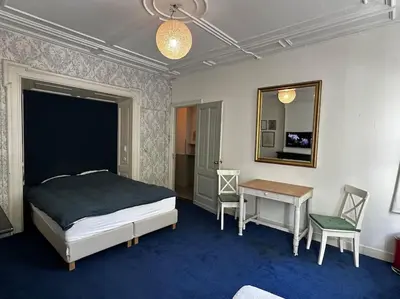 a bedroom with a bed and a table and a mirror at De Stijlkamer in Amsterdam