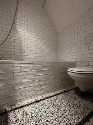 a white bathroom with a toilet and a shower at De Stijlkamer in Amsterdam