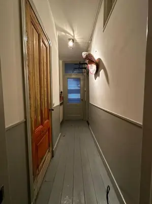 a hallway of an empty room with a door and a hallway at De Stijlkamer in Amsterdam
