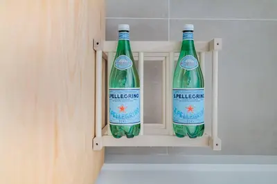 two bottles of water sitting in a cabinet at Chique Ibiza Zaandam in Zaandam