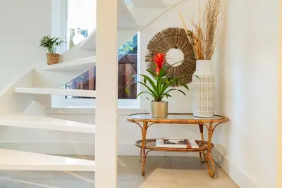 a table with a plant on it next to a staircase at Chique Ibiza Zaandam in Zaandam