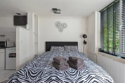 a bedroom with a bed with two stuffed animals on it at Zaras Studio Hermes in Zandvoort