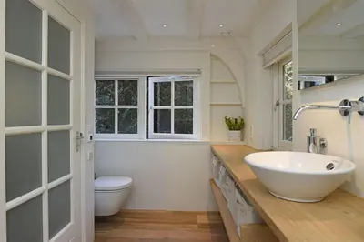 a bathroom with a white sink and a toilet at Natuurhuis in het Gooi in Naarden