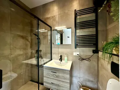 a bathroom with a sink and a shower at Modern Appartment Free Parking in Zandvoort