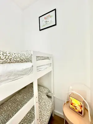 a bedroom with bunk beds and a table at Modern Appartment Free Parking in Zandvoort