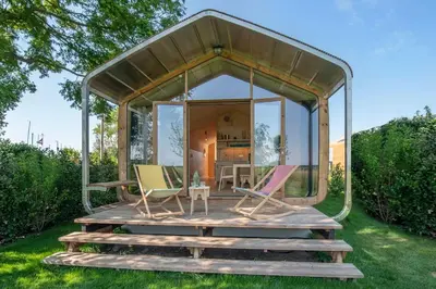 a pavilion with chairs and a table on a deck at Huisje te huur van 15 feb tot 15 mrt voor tweeduizend euro vier weken in Zevenhuizen