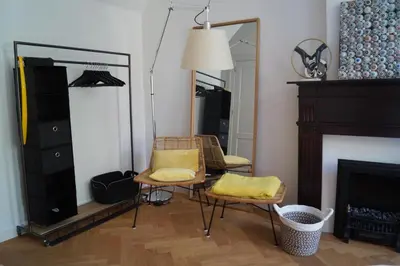a living room with two chairs and a mirror at Banzai City Amsterdam in Amsterdam