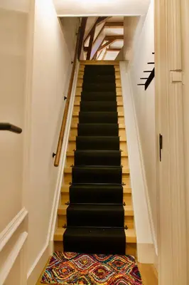 a staircase with black treads in a house at Banzai City Amsterdam in Amsterdam