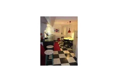 a view of a kitchen and a living room at Banzai City Amsterdam in Amsterdam