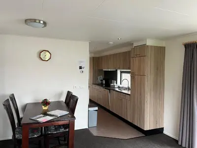 a kitchen with a table and a dining room at Vinkestek Verhuur in Vinkeveen