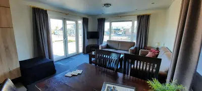 a living room with a table and a couch at Vinkestek Verhuur in Vinkeveen