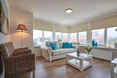 a living room with a couch and a table at Apartments Four Seasons Voorstraat in Egmond aan Zee