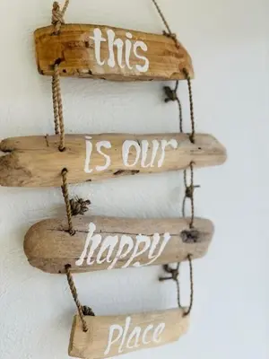 a couple of wooden signs that say this is our happy place at Apartments Four Seasons Voorstraat in Egmond aan Zee