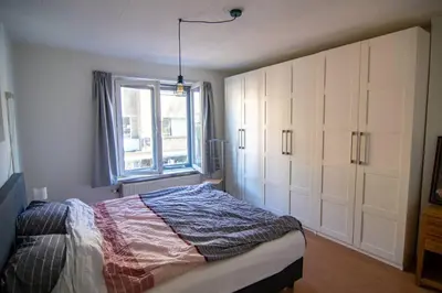 a bedroom with a bed and a window at Centre Hilversum, 20 minutes train to Amsterdam in Hilversum
