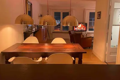 a dining room with a wooden table and chairs at Centre Hilversum, 20 minutes train to Amsterdam in Hilversum