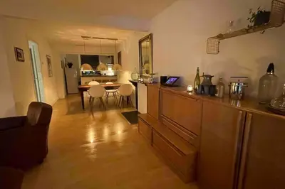 a living room with a kitchen and a dining room at Centre Hilversum, 20 minutes train to Amsterdam in Hilversum