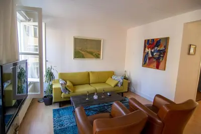 a living room with a couch and a table at Centre Hilversum, 20 minutes train to Amsterdam in Hilversum