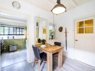 a dining room with a wooden table and chairs at Cosy Bergen in Bergen