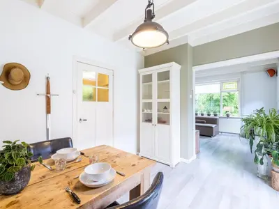 a dining room with a wooden table and chairs at Cosy Bergen in Bergen