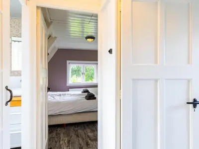 a bedroom with a bed and a window at Cosy Bergen in Bergen