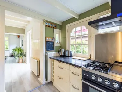 a kitchen with a stove top oven in a room at Cosy Bergen in Bergen