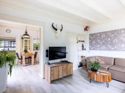 a living room with a couch and a tv at Cosy Bergen in Bergen