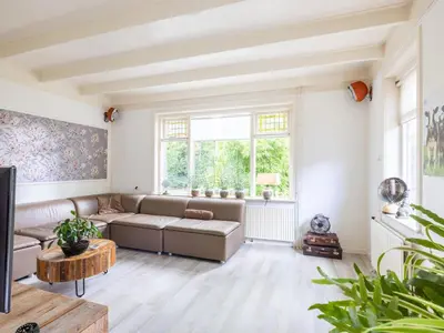 a living room with a couch and a table at Cosy Bergen in Bergen