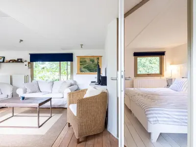 a living room with a bed and a couch at Vlinder in Bergen