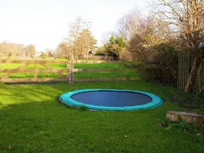 a small blue pool in the middle of a yard at Vlinder in Bergen