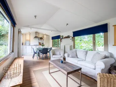 a living room with a couch and a table at Vlinder in Bergen