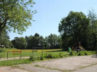 a park with a playground and an old playground at De egelhut in Bergen